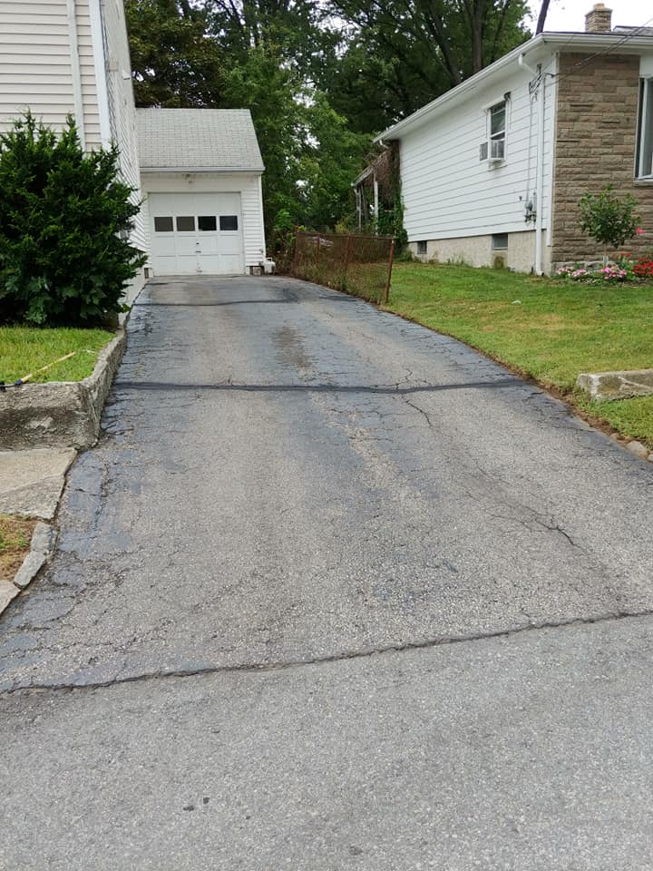 Old, cracked driveway before seal coat