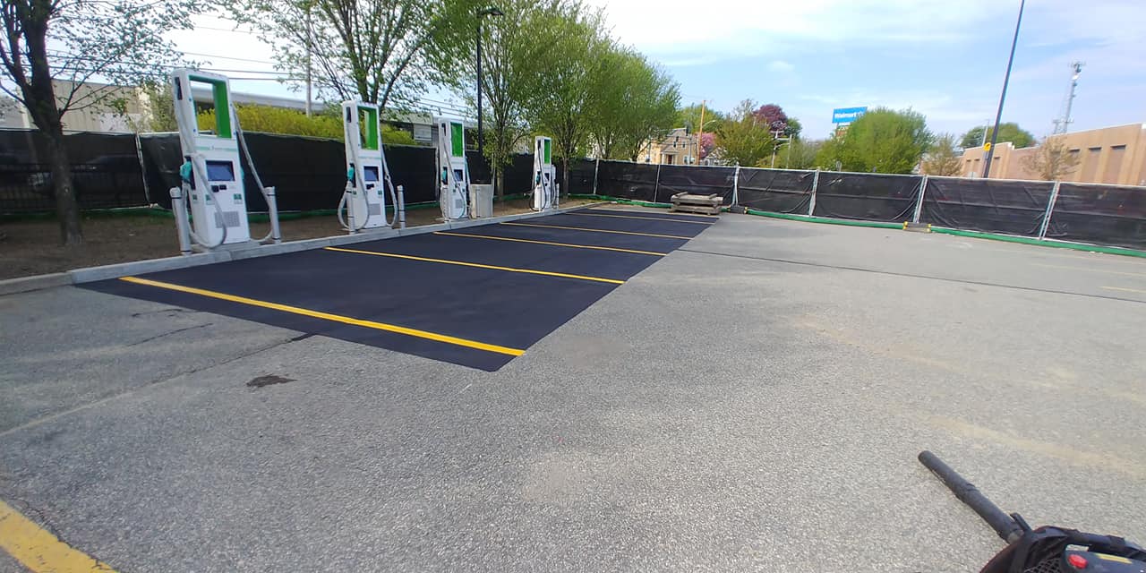 Fresh seal coat and yellow lines for vehicle charging station