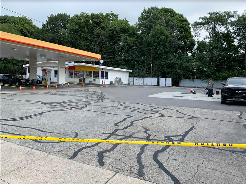 Gas station lot with cracks that need sealing