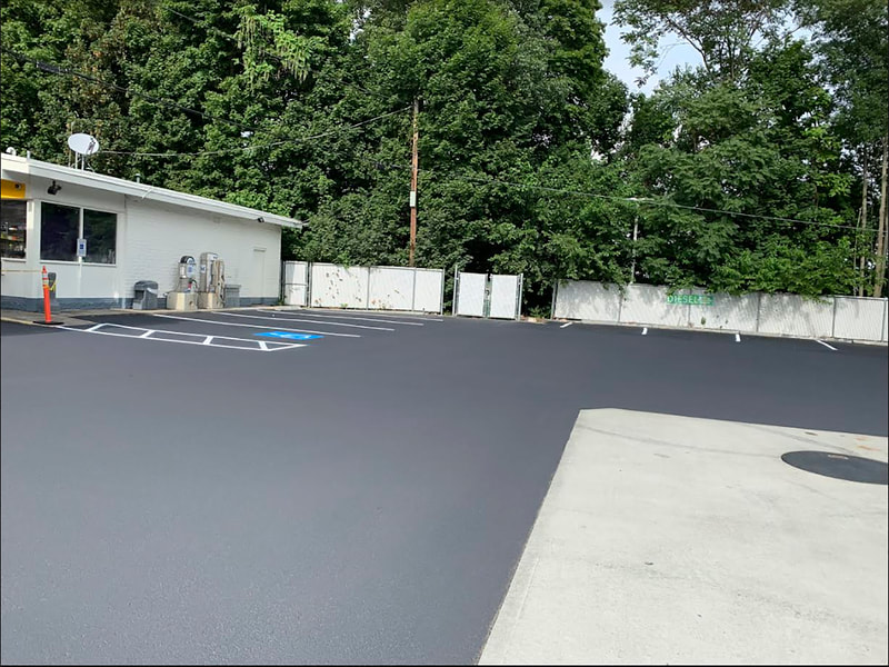 Fresh seal coat on gas station lot with new lot lines